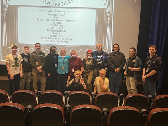 Jersey Devil Film Festival winners and filmmakers celebrating in theater.