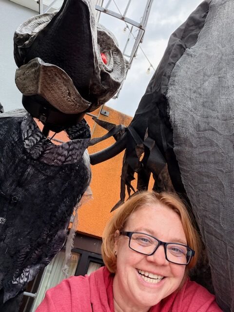 Jersey Devil creature statue and vendor at the Jersey Devil Fable Festival.